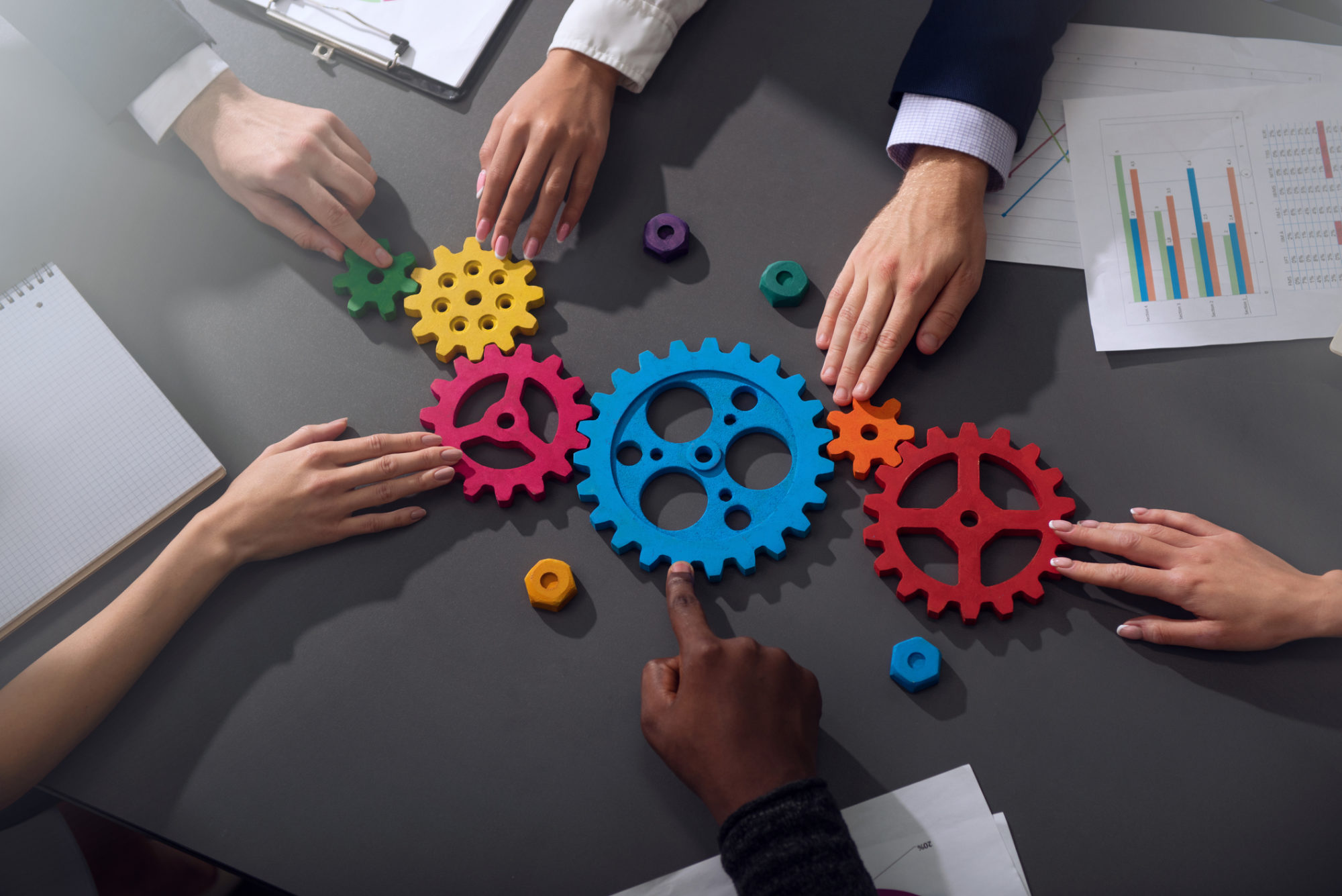 Business team connect pieces of gears. Teamwork, partnership and integration concept